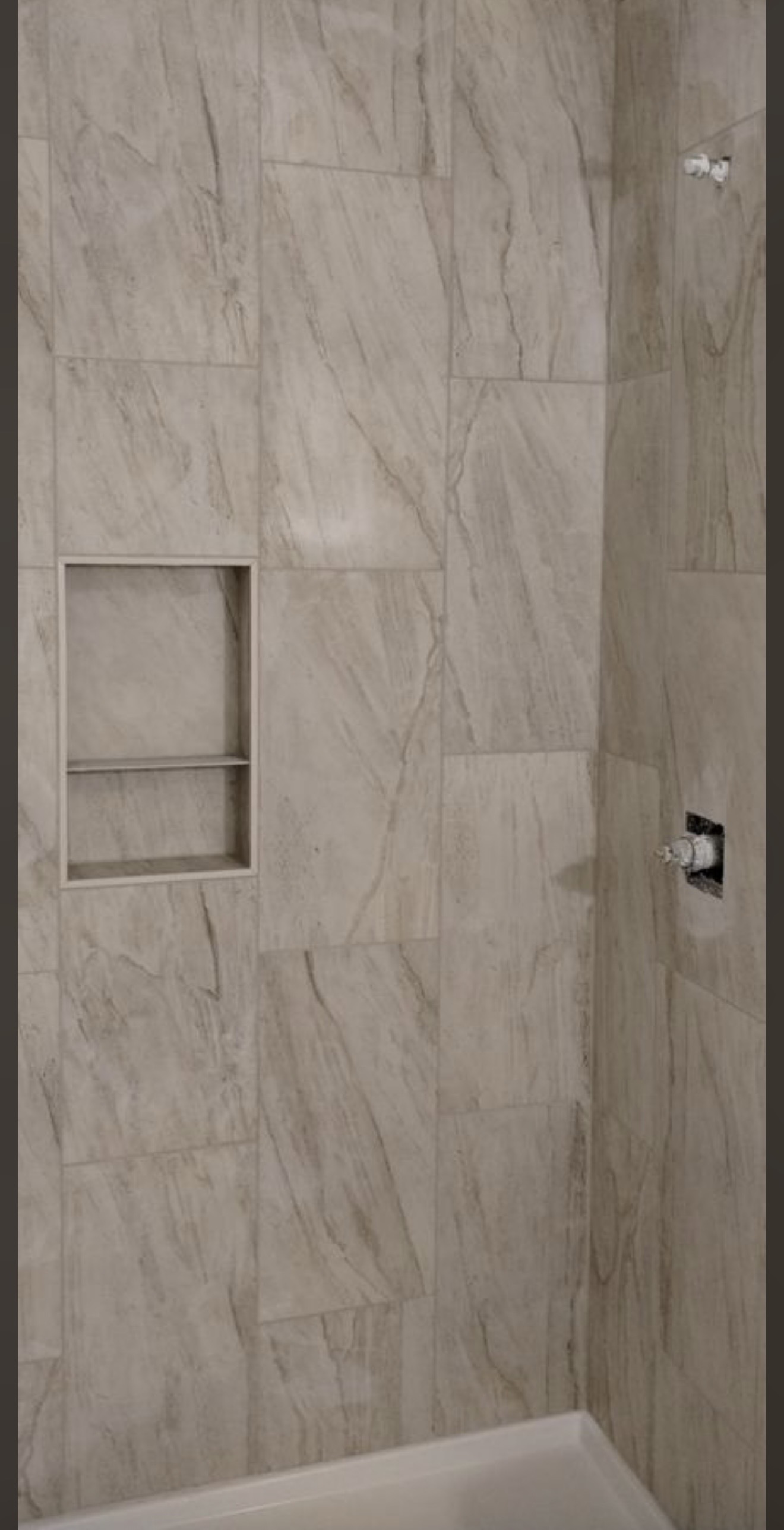 Marble shower with built-in niche.